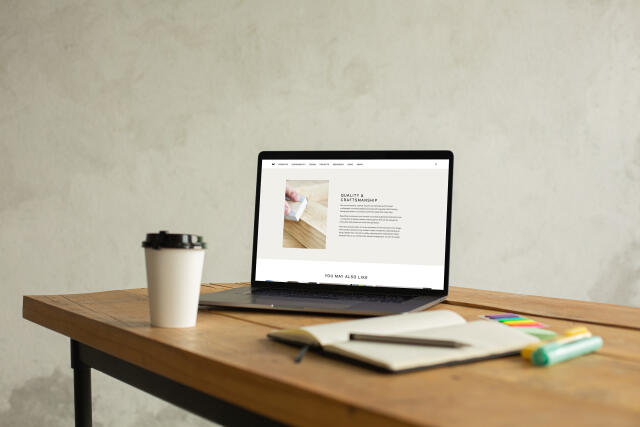 mockuuups macbook pro mockup on a table beside a cup of coffee