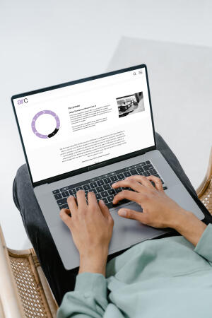 mockuuups grey macbook mockup on a users lap