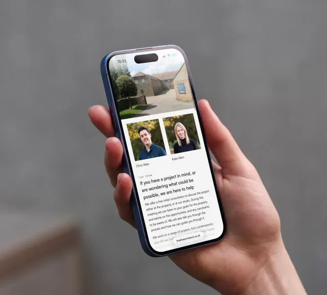 mockuuups iphone 16 mockup in a womans hand with concrete backdrop