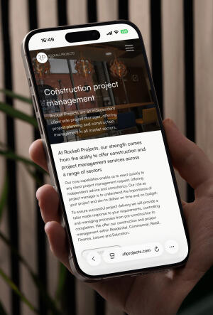 mockuuups iphone 15 pro mockup in a male hand against a modern backdrop