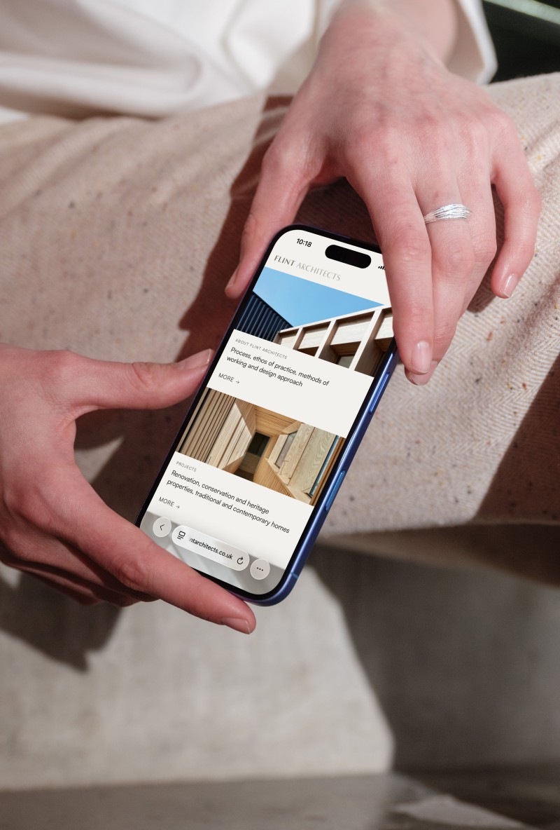 mockuuups woman holding iphone 16