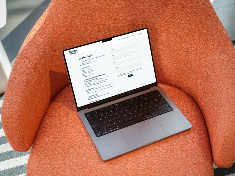 mockuuups macbook pro mockup on an orange textured armchair